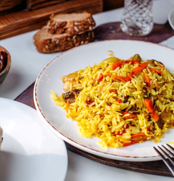 front-view-cooked-rice-with-fresh-sliced-vegetables-inside-white-plate-white-floor
